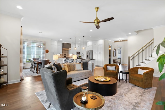 241 Teague St, Wake Forest, NC 27587 - living area featuring a ceiling fan, wood finished floors, recessed lighting, stairway, and crown molding