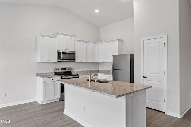 3837 Ava Dr, Bailey, NC 27807 - kitchen with stainless steel appliances, white cabinets, a center island with sink, and high vaulted ceiling