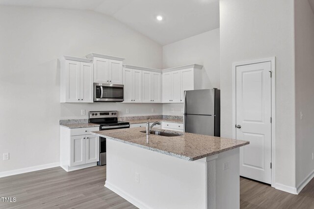 3837 Ava Dr, Bailey, NC 27807 - kitchen with stainless steel appliances, white cabinets, a center island with sink, and high vaulted ceiling