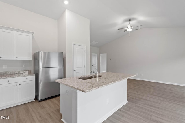 3837 Ava Dr, Bailey, NC 27807 - kitchen featuring freestanding refrigerator, vaulted ceiling, ceiling fan, light wood-style flooring, and white cabinets