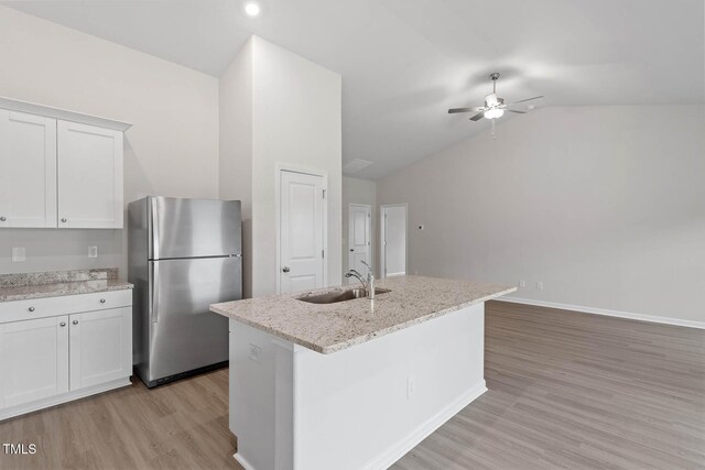 3837 Ava Dr, Bailey, NC 27807 - kitchen featuring freestanding refrigerator, vaulted ceiling, ceiling fan, light wood-style flooring, and white cabinets