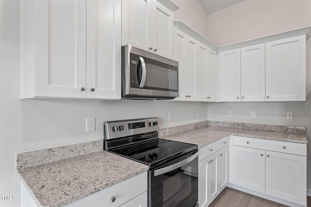 3837 Ava Dr, Bailey, NC 27807 - kitchen with stainless steel appliances, white cabinets, and light stone counters