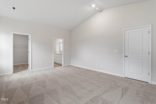 3837 Ava Dr, Bailey, NC 27807 - unfurnished bedroom with lofted ceiling, carpet floors, a spacious closet, ensuite bathroom, and a closet