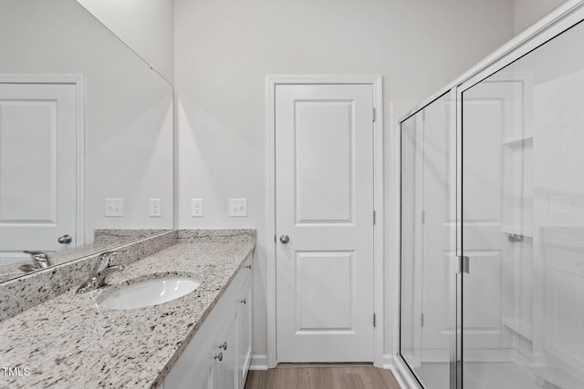 3837 Ava Dr, Bailey, NC 27807 - bathroom featuring vanity, a stall shower, and wood finished floors