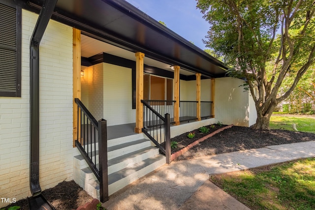 944 Athens Dr, Raleigh, NC 27606 - view of exterior entry featuring brick siding and a porch