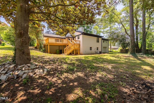 944 Athens Dr, Raleigh, NC 27606 - rear view of house featuring stairway, a wooden deck, an attached garage, and a chimney