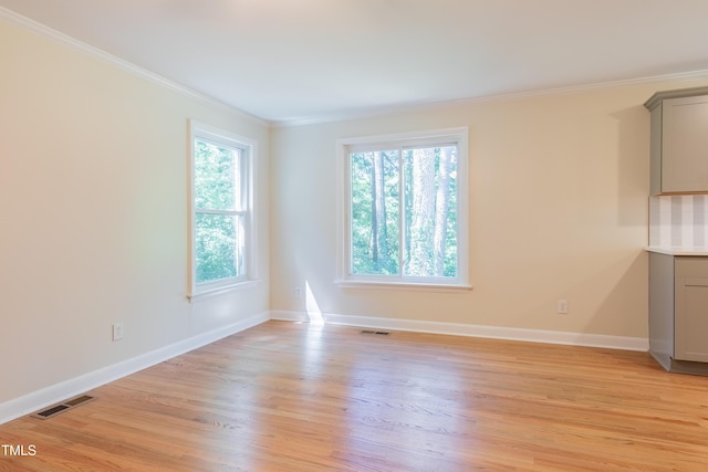 944 Athens Dr, Raleigh, NC 27606 - spare room with light wood-style floors and crown molding