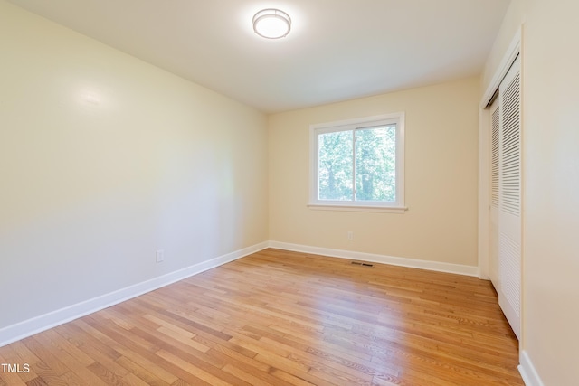 944 Athens Dr, Raleigh, NC 27606 - unfurnished bedroom featuring light wood finished floors and a closet