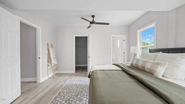 505 Hawfields Rd, Mebane, NC 27302 - bedroom featuring light wood-style floors, a spacious closet, ceiling fan, and a closet