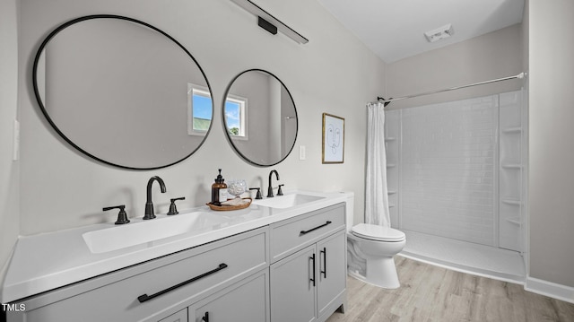 505 Hawfields Rd, Mebane, NC 27302 - full bath featuring wood finished floors, double vanity, and tiled shower