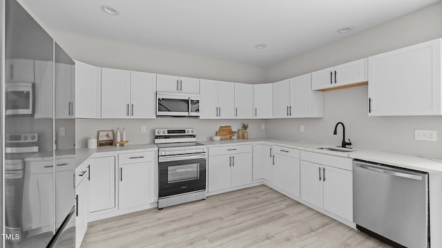 505 Hawfields Rd, Mebane, NC 27302 - kitchen featuring stainless steel appliances, light wood finished floors, white cabinetry, and recessed lighting