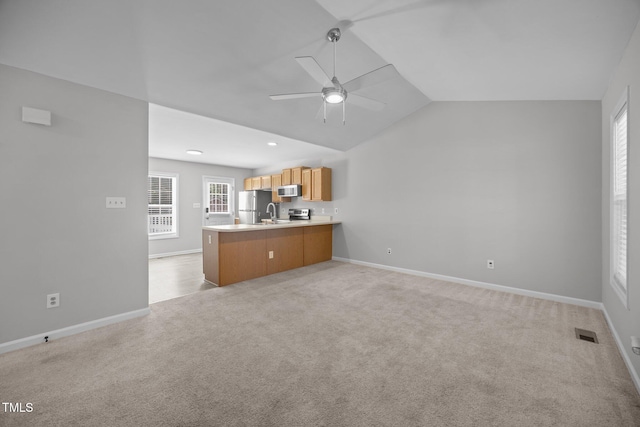 119 Percheron Dr, Zebulon, NC 27597 - unfurnished living room with a ceiling fan, vaulted ceiling, and light colored carpet
