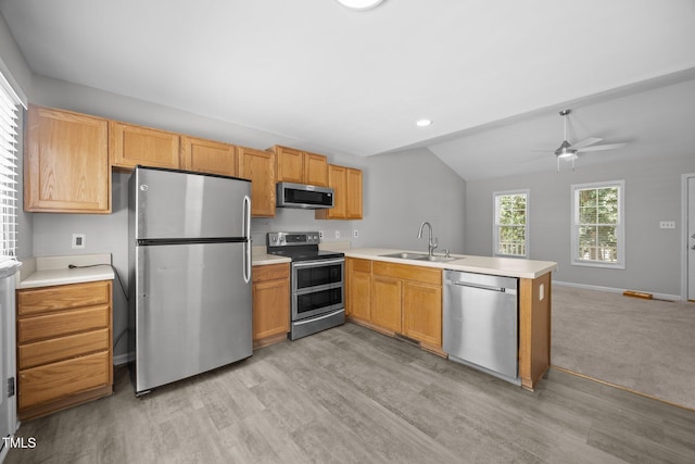 119 Percheron Dr, Zebulon, NC 27597 - kitchen featuring stainless steel appliances, a peninsula, lofted ceiling, light wood-type flooring, and open floor plan