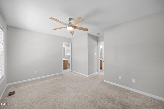 119 Percheron Dr, Zebulon, NC 27597 - unfurnished bedroom featuring light colored carpet, ensuite bath, and multiple windows