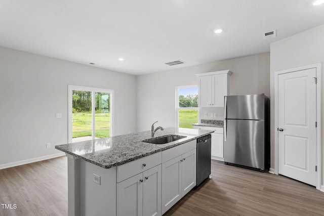 3930 Needham Rd, Bailey, NC 27807 - kitchen with appliances with stainless steel finishes, light stone countertops, wood finished floors, white cabinetry, and recessed lighting
