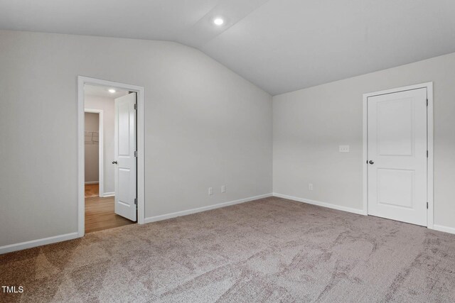 3930 Needham Rd, Bailey, NC 27807 - spare room featuring carpet, lofted ceiling, and recessed lighting