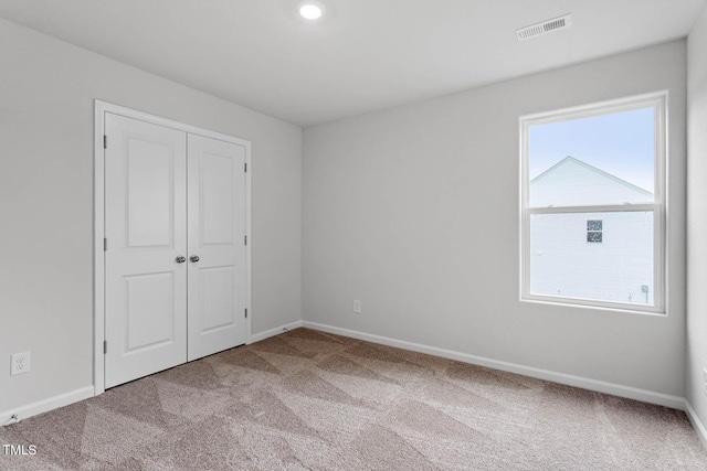 3930 Needham Rd, Bailey, NC 27807 - unfurnished bedroom featuring carpet floors, a closet, and recessed lighting