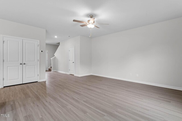 3930 Needham Rd, Bailey, NC 27807 - unfurnished living room featuring a ceiling fan, stairs, wood finished floors, and recessed lighting