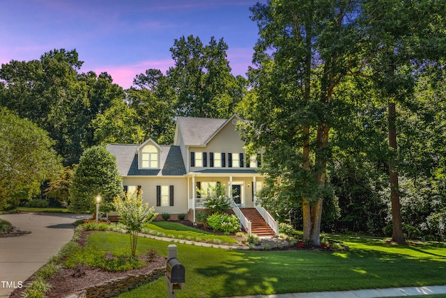 5940 Dahlberg Dr, Raleigh, NC 27603 - view of front facade featuring stairs, a lawn, and covered porch