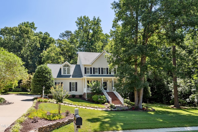 5940 Dahlberg Dr, Raleigh, NC 27603 - colonial inspired home with stairway, a front yard, and covered porch