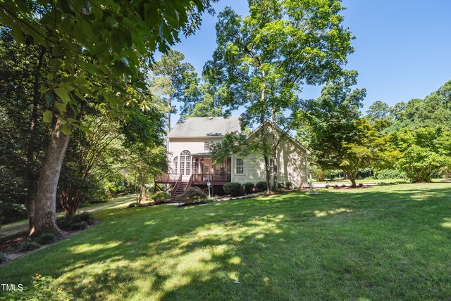 5940 Dahlberg Dr, Raleigh, NC 27603 - view of grassy yard featuring a deck and stairway
