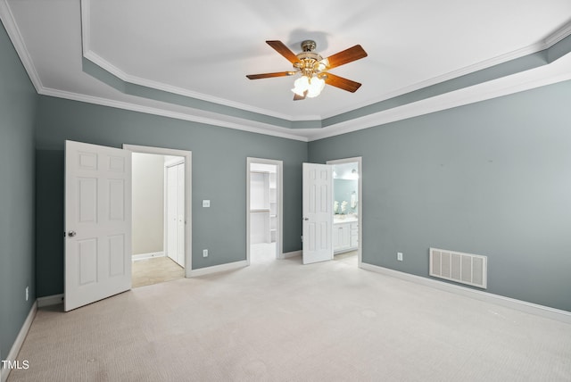 5940 Dahlberg Dr, Raleigh, NC 27603 - unfurnished bedroom featuring carpet flooring, a raised ceiling, ensuite bath, crown molding, and ceiling fan
