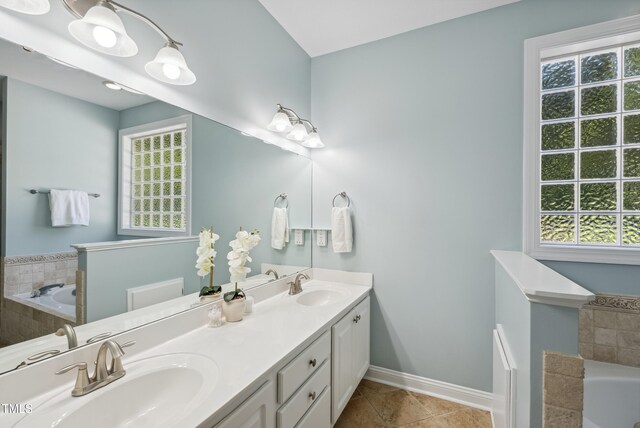 5940 Dahlberg Dr, Raleigh, NC 27603 - bathroom with a bath, double vanity, and tile patterned flooring