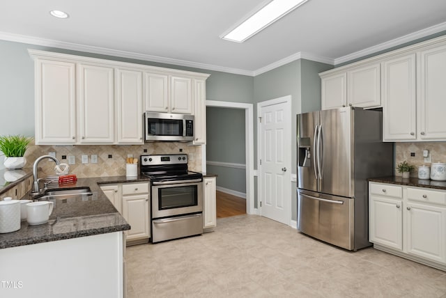 5940 Dahlberg Dr, Raleigh, NC 27603 - kitchen with appliances with stainless steel finishes, ornamental molding, backsplash, dark stone countertops, and white cabinets