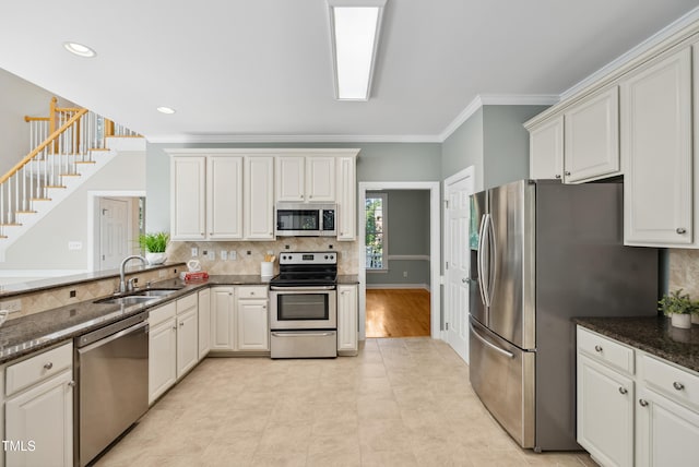 5940 Dahlberg Dr, Raleigh, NC 27603 - kitchen with appliances with stainless steel finishes, ornamental molding, backsplash, dark stone counters, and recessed lighting