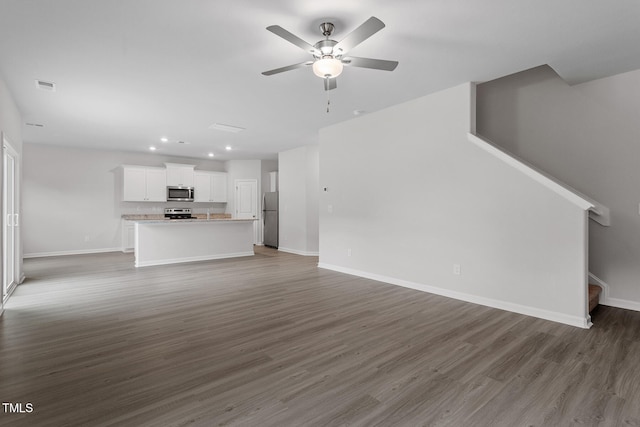 3870 Origin Dr, Bailey, NC 27807 - unfurnished living room with stairs, ceiling fan, wood finished floors, and recessed lighting
