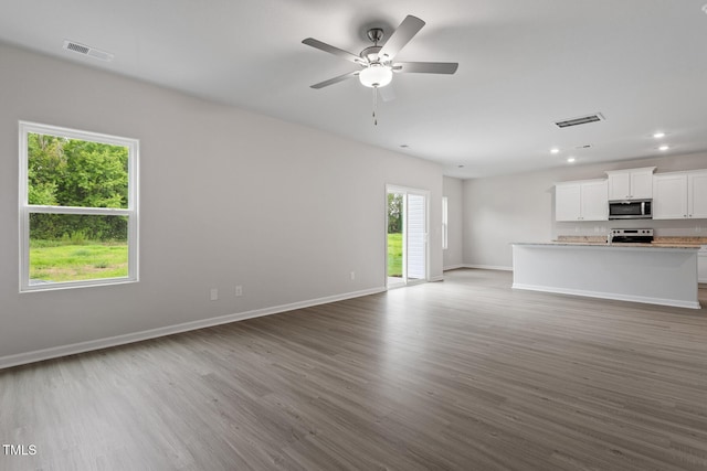 3870 Origin Dr, Bailey, NC 27807 - unfurnished living room featuring dark wood-type flooring, ceiling fan, and recessed lighting