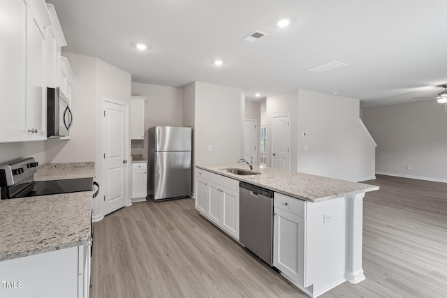 3870 Origin Dr, Bailey, NC 27807 - kitchen with appliances with stainless steel finishes, light wood-type flooring, white cabinetry, a ceiling fan, and recessed lighting