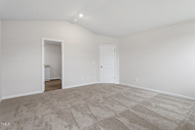 3870 Origin Dr, Bailey, NC 27807 - unfurnished bedroom featuring vaulted ceiling, carpet, and ensuite bathroom