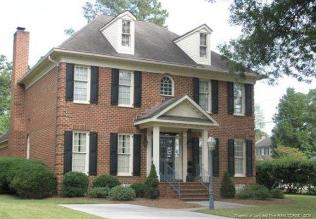 223 Devane St, Fayetteville, NC 28305 - colonial house with a chimney and brick siding