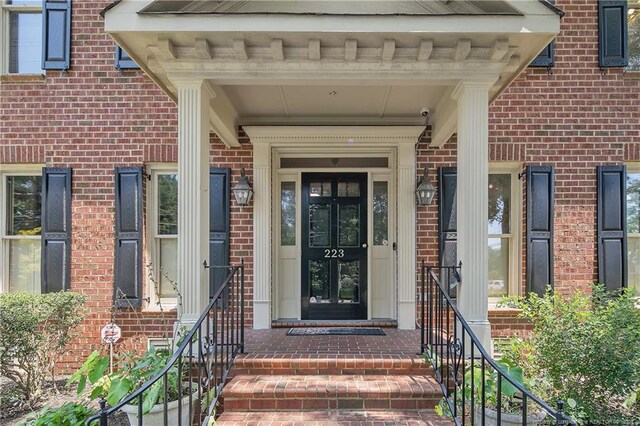223 Devane St, Fayetteville, NC 28305 - property entrance with brick siding and a surveillance system