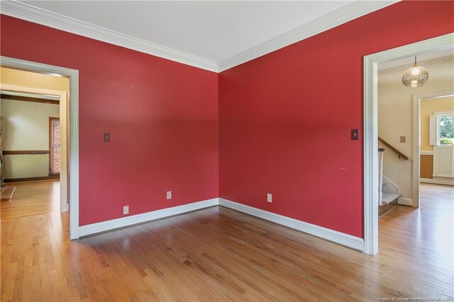 223 Devane St, Fayetteville, NC 28305 - unfurnished room featuring wood finished floors, ornamental molding, and stairway