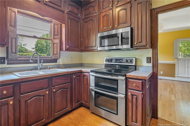 223 Devane St, Fayetteville, NC 28305 - kitchen featuring appliances with stainless steel finishes, light countertops, and light wood-style flooring