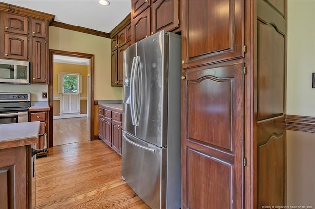 223 Devane St, Fayetteville, NC 28305 - kitchen featuring stainless steel appliances, light wood-style floors, ornamental molding, recessed lighting, and light countertops