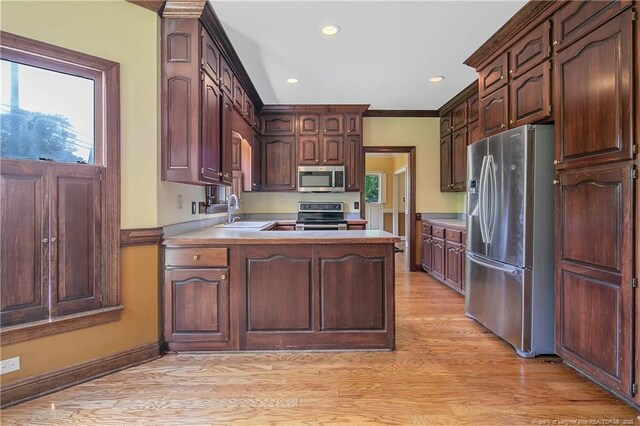 223 Devane St, Fayetteville, NC 28305 - kitchen featuring stainless steel appliances, light wood-type flooring, a peninsula, light countertops, and recessed lighting