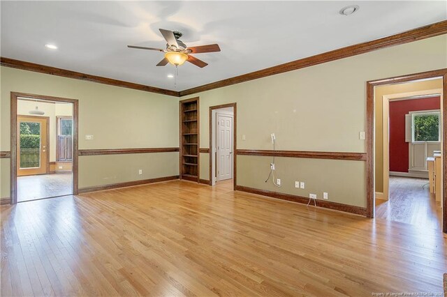 223 Devane St, Fayetteville, NC 28305 - empty room with crown molding, ceiling fan, light wood-type flooring, built in shelves, and recessed lighting