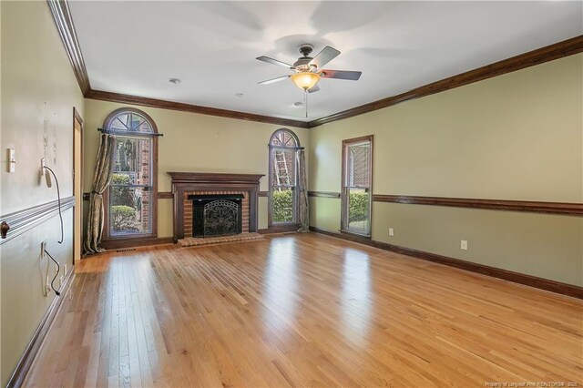 223 Devane St, Fayetteville, NC 28305 - unfurnished living room with ceiling fan, light wood finished floors, a fireplace, and crown molding