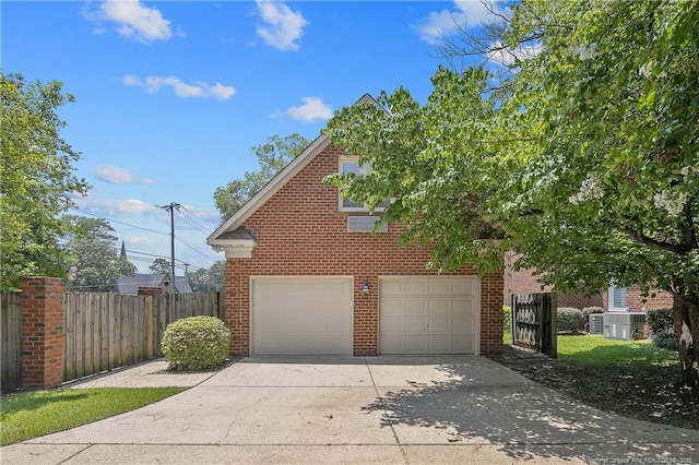 223 Devane St, Fayetteville, NC 28305 - view of home's exterior with concrete driveway, an attached garage, and brick siding