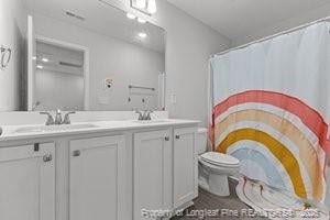 360 Carolina Church Rd, Saint Paul, NC 28384 - full bath with double vanity and a shower with curtain