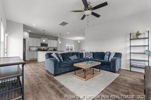 360 Carolina Church Rd, Saint Paul, NC 28384 - living area featuring ceiling fan and wood finished floors