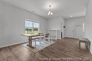 360 Carolina Church Rd, Saint Paul, NC 28384 - dining space with wood finished floors and a chandelier