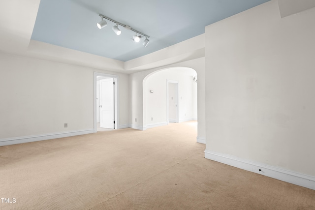 235 Mccauley St Unit # D, Chapel Hill, NC 27516 - spare room with track lighting, light colored carpet, arched walkways, and a raised ceiling