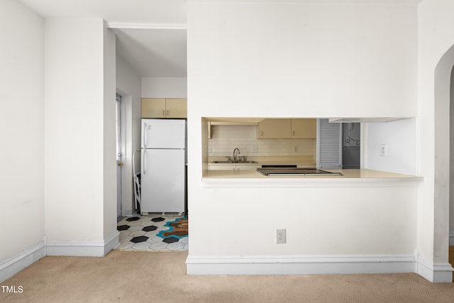 235 Mccauley St Unit # D, Chapel Hill, NC 27516 - kitchen with freestanding refrigerator, light colored carpet, black electric stovetop, tasteful backsplash, and light countertops