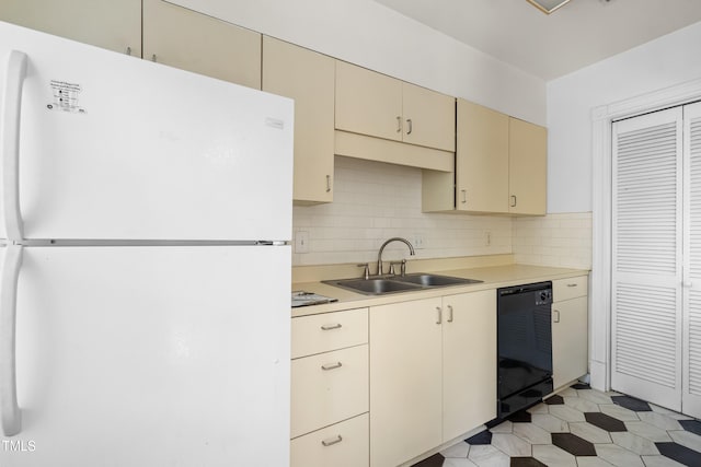235 Mccauley St Unit # D, Chapel Hill, NC 27516 - kitchen featuring freestanding refrigerator, black dishwasher, cream cabinets, light countertops, and tasteful backsplash