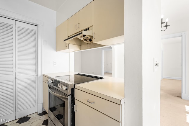 235 Mccauley St Unit # D, Chapel Hill, NC 27516 - kitchen featuring electric stove, cream cabinets, under cabinet range hood, and light countertops