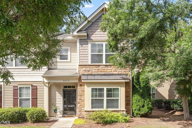 7879 Allscott Way, Raleigh, NC 27612 - view of front of home featuring stone siding and a standing seam roof